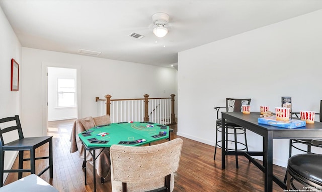 game room with a ceiling fan, visible vents, baseboards, and hardwood / wood-style flooring