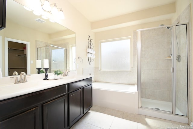 bathroom with tile patterned flooring, a sink, visible vents, double vanity, and a stall shower