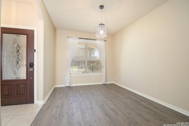 interior space with baseboards and wood finished floors