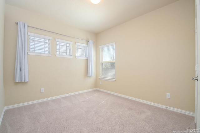 carpeted empty room with baseboards