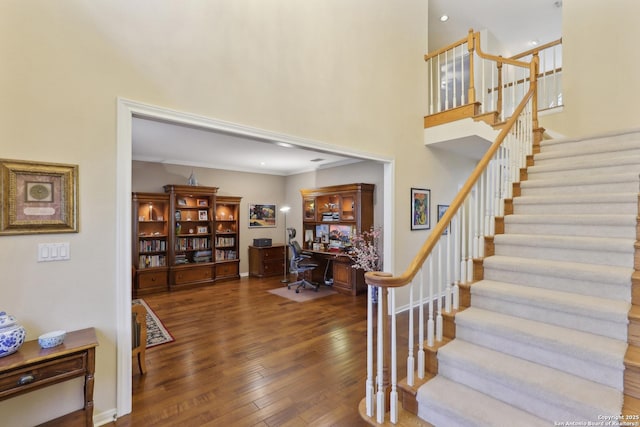 entryway featuring recessed lighting, stairway, a high ceiling, hardwood / wood-style floors, and baseboards