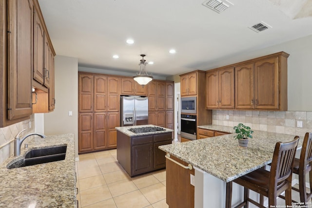 17110 Eagle Holw, San Antonio, TX 78248 - kitchen featuring stainless steel appliances, visible vents, a sink, light stone countertops, and a peninsula
