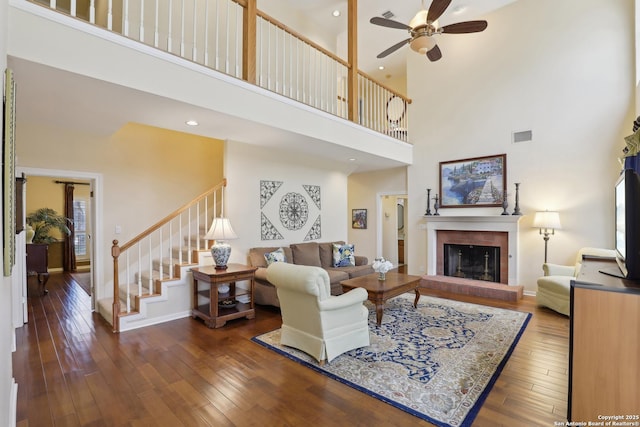 17110 Eagle Holw, San Antonio, TX 78248 - living room featuring ceiling fan, a fireplace, visible vents, stairs, and dark wood finished floors