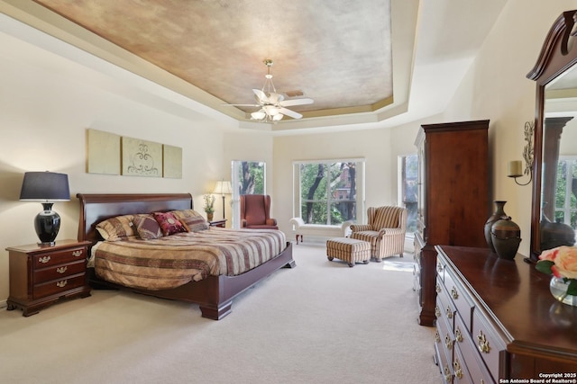 17110 Eagle Holw, San Antonio, TX 78248 - bedroom with light carpet, ceiling fan, visible vents, and a tray ceiling