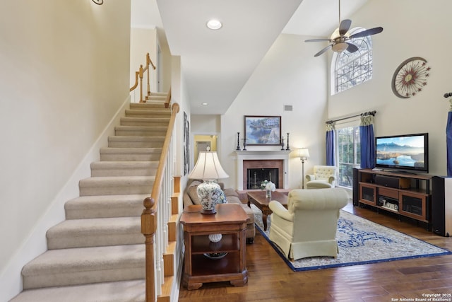 17110 Eagle Holw, San Antonio, TX 78248 - living area featuring a fireplace, wood finished floors, visible vents, a ceiling fan, and stairs