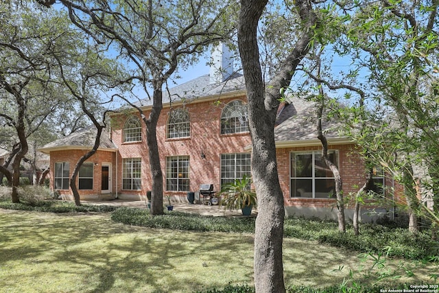 17110 Eagle Holw, San Antonio, TX 78248 - rear view of house with brick siding, a patio, and a lawn