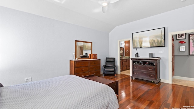 bedroom featuring dark wood-style floors, vaulted ceiling, baseboards, and a ceiling fan