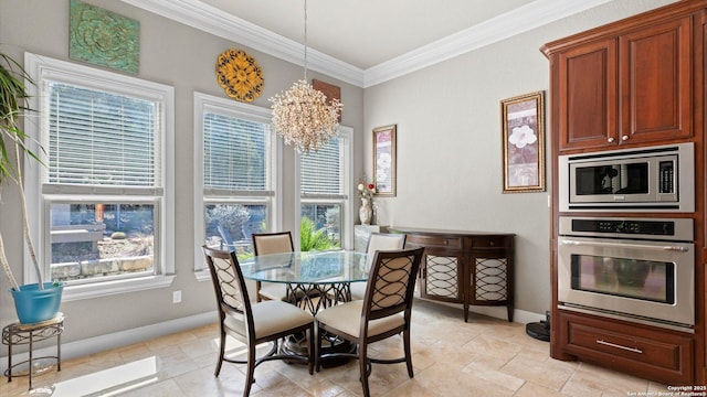 dining area with an inviting chandelier, baseboards, and ornamental molding