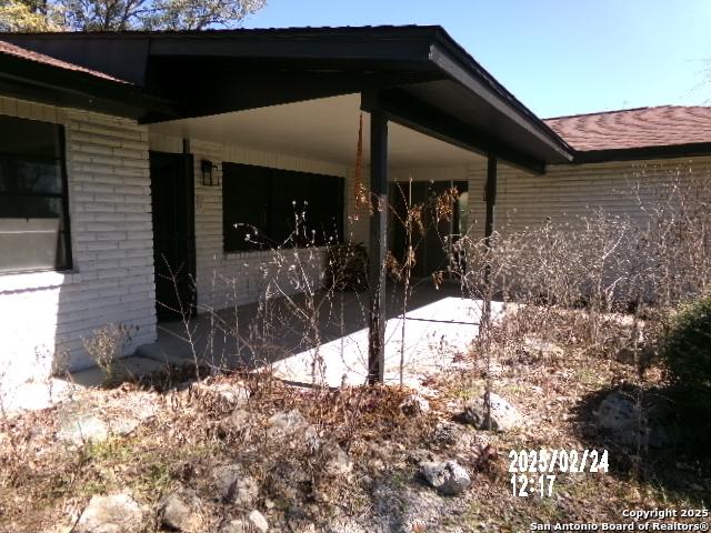 view of property exterior featuring brick siding