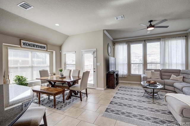 living room with light tile patterned flooring, visible vents, and a healthy amount of sunlight