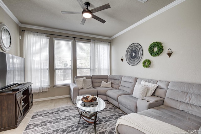 living area featuring a textured ceiling, ornamental molding, a ceiling fan, and baseboards