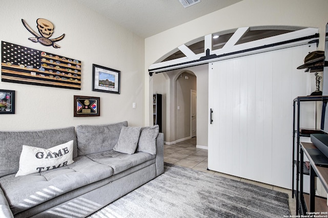 tiled living area featuring arched walkways