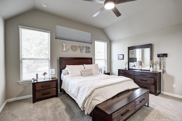 bedroom with light carpet, multiple windows, baseboards, and vaulted ceiling