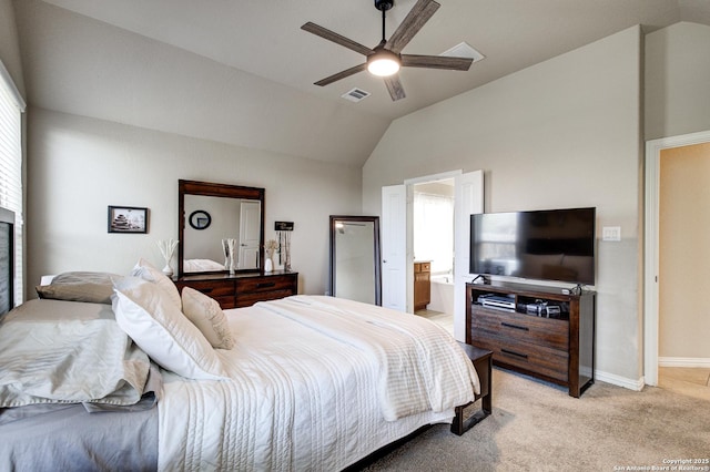 bedroom with visible vents, light colored carpet, ceiling fan, ensuite bathroom, and vaulted ceiling