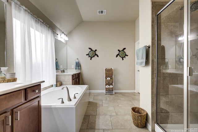 bathroom featuring visible vents, two vanities, a garden tub, a shower stall, and a sink