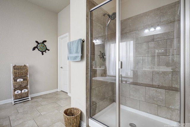 full bathroom with a shower stall and baseboards