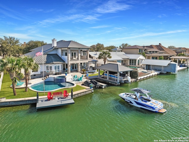 dock area featuring a patio, a water view, a residential view, and a pool with connected hot tub