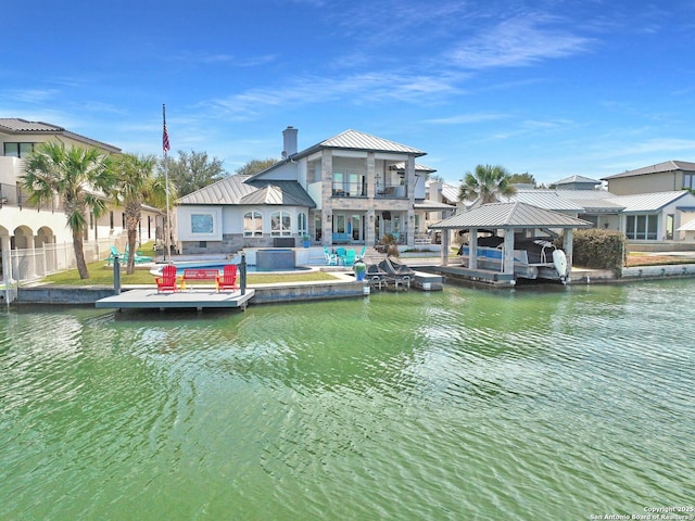 view of dock with a water view, fence, a pool, and a gazebo