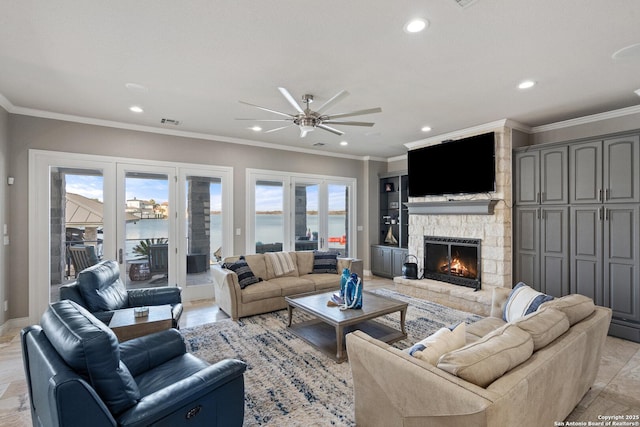 404 Matern Ct, Horseshoe Bay, TX 78657 - living area featuring ornamental molding, recessed lighting, a healthy amount of sunlight, and a stone fireplace