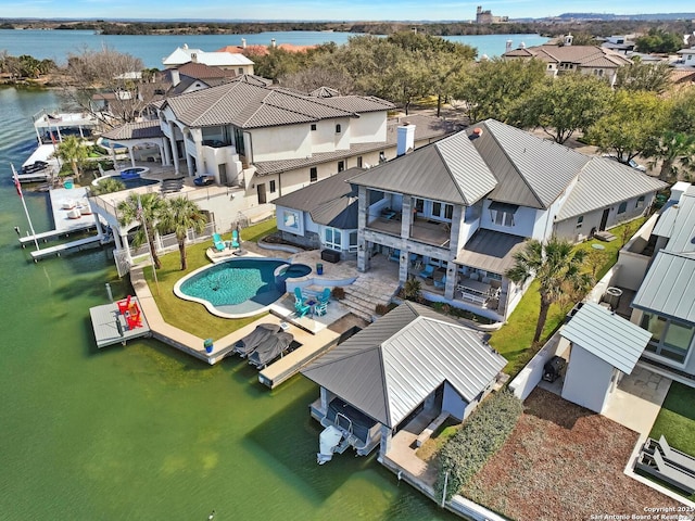 drone / aerial view featuring a residential view and a water view