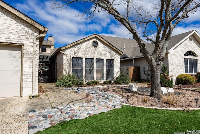 view of front facade featuring stone siding, a chimney, and a front lawn