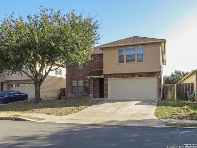 view of front of home featuring brick siding, concrete driveway, an attached garage, fence, and stucco siding