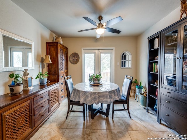 dining space with light tile patterned floors, french doors, and a ceiling fan