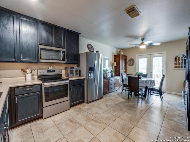 kitchen featuring light tile patterned flooring, visible vents, stainless steel appliances, and french doors