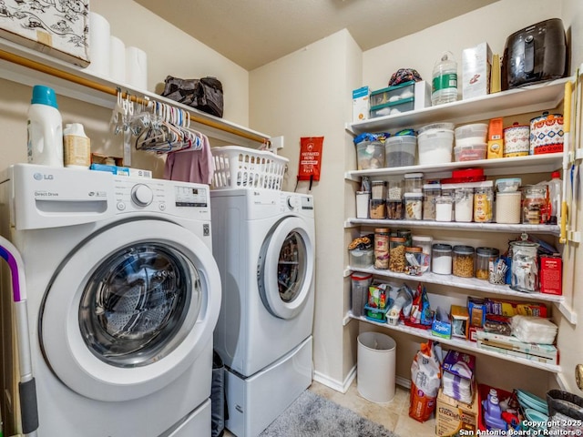 laundry area featuring laundry area, independent washer and dryer, and tile patterned flooring