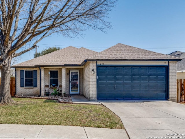 ranch-style home with a garage, roof with shingles, a front yard, and fence