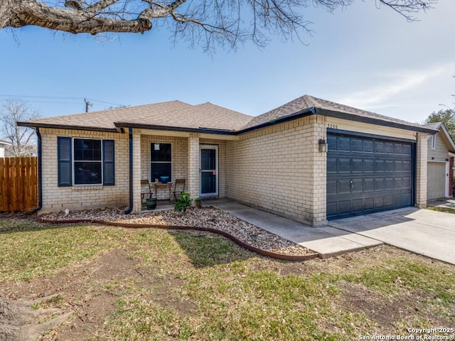 ranch-style house featuring a garage, concrete driveway, brick siding, and fence