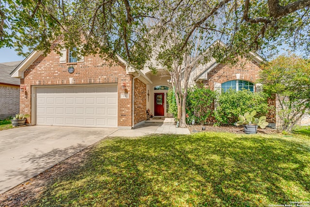 traditional home with a garage, concrete driveway, brick siding, and a front lawn