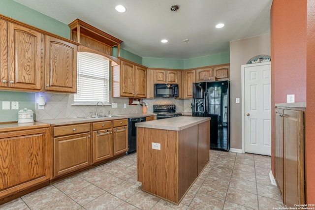 kitchen featuring decorative backsplash, light countertops, a sink, and black appliances