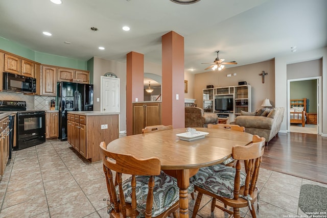 dining area with a ceiling fan, recessed lighting, arched walkways, and light tile patterned floors