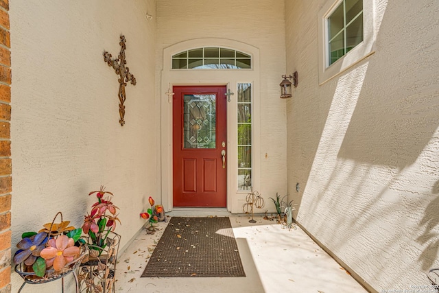 entrance to property featuring stucco siding