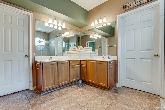 full bath featuring double vanity, tile patterned flooring, a tile shower, and a sink