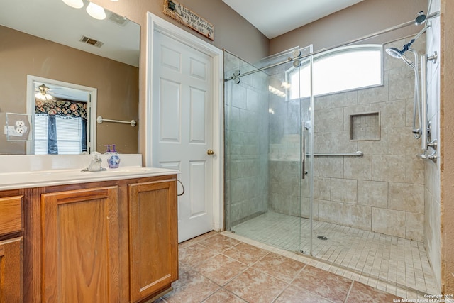 bathroom with a stall shower, tile patterned flooring, visible vents, and vanity