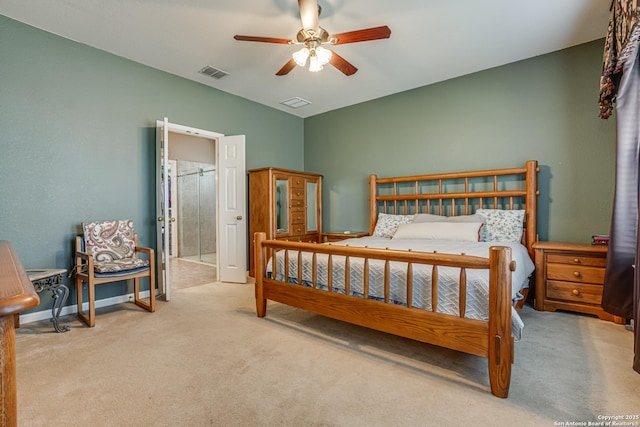 carpeted bedroom featuring lofted ceiling, baseboards, visible vents, and ensuite bathroom