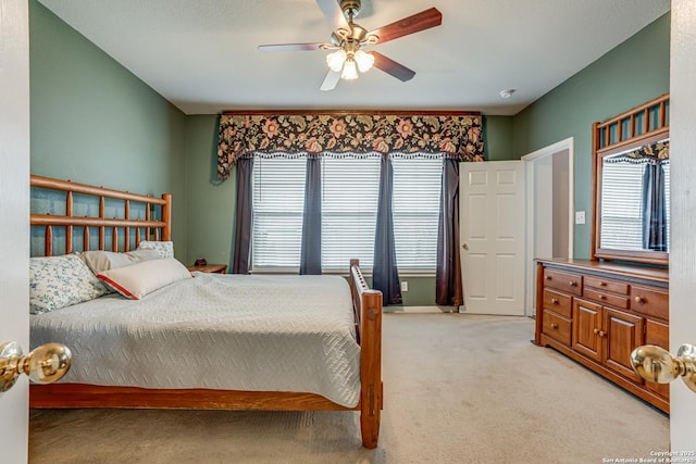 bedroom with light colored carpet and ceiling fan