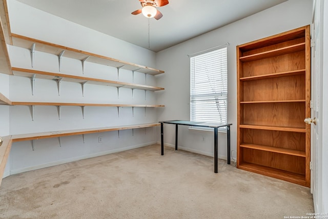 unfurnished office featuring ceiling fan, carpet, and baseboards