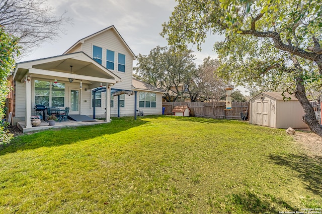 back of house with a patio, a lawn, a storage shed, fence, and an outdoor structure