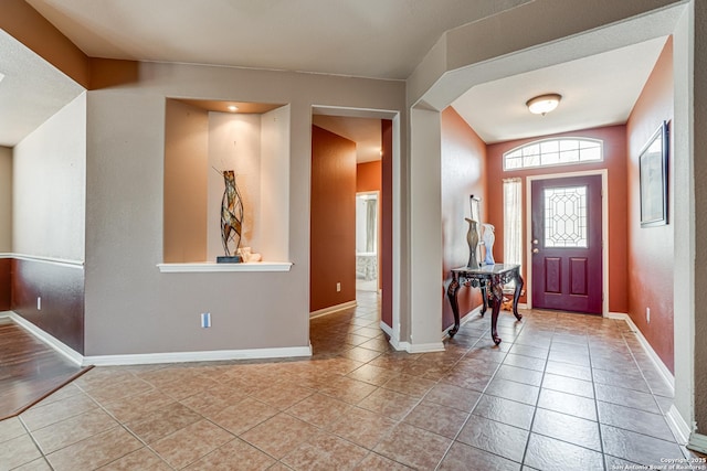 entrance foyer featuring baseboards and light tile patterned floors