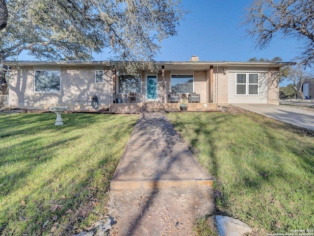 single story home featuring a chimney and a front yard