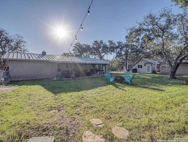 view of yard featuring an outdoor fire pit