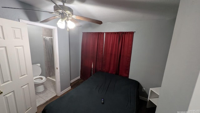 bedroom with ceiling fan, baseboards, and tile patterned floors