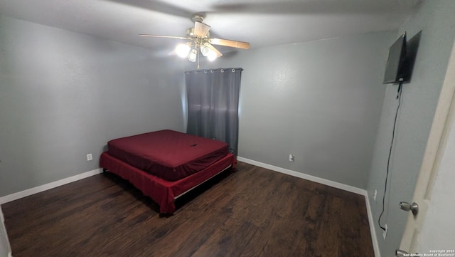 bedroom with ceiling fan, baseboards, and wood finished floors