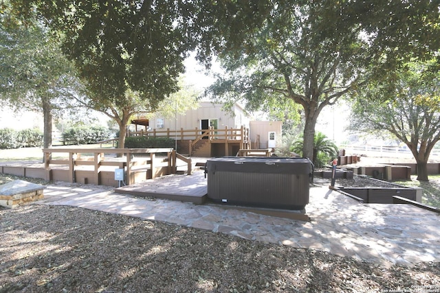 view of patio with a deck, central AC, and a hot tub