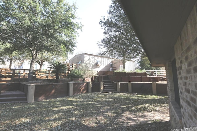 view of yard with a deck and stairs