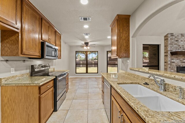 1300 Windmill Dr, La Vernia, TX 78121 - kitchen with a textured ceiling, visible vents, appliances with stainless steel finishes, and a sink