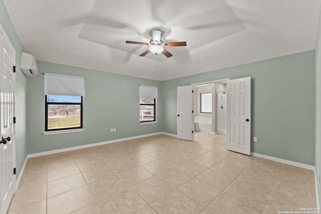 1300 Windmill Dr, La Vernia, TX 78121 - unfurnished room featuring a wall mounted air conditioner, baseboards, a healthy amount of sunlight, and ceiling fan
